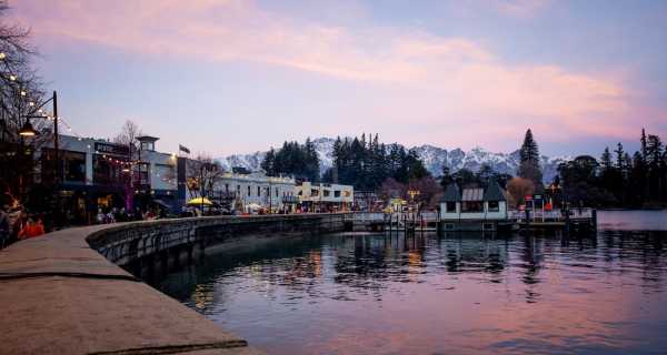 Queenstown waterfront in winter at sunset with the Remarkables mountain range covered in snow