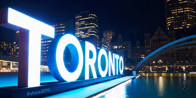 The Toronto Sign at Nathan Phillips Square lit blue
