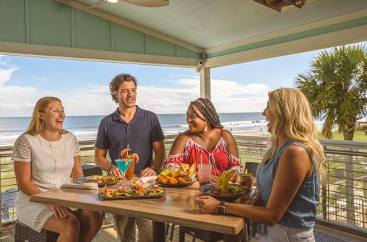 A group of friends enjoys an oceanfront meal at Snooky's Oceanfront