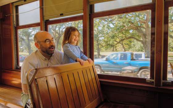 A father and daughter enjoying the St. Charles Avenue Streetcar together
