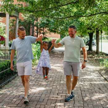 Couple walking with daughter in German Village