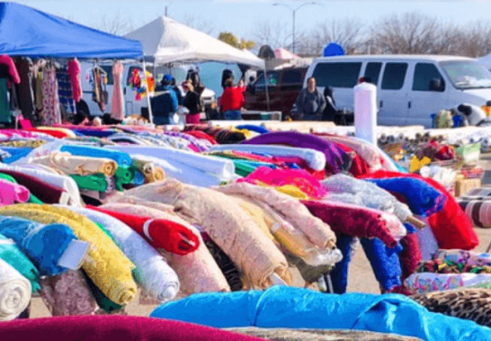 dress fabrics arranged on street stands to attract customers