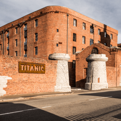 Outside of Titanic Hotel Liverpool from the road. The hotel is a transformed warehouse style building.