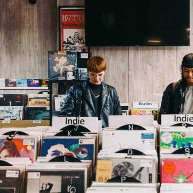 Two people stood looking at records in the record store.
