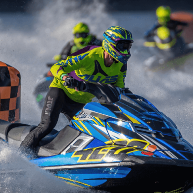 A person on a jet ski racing on water.