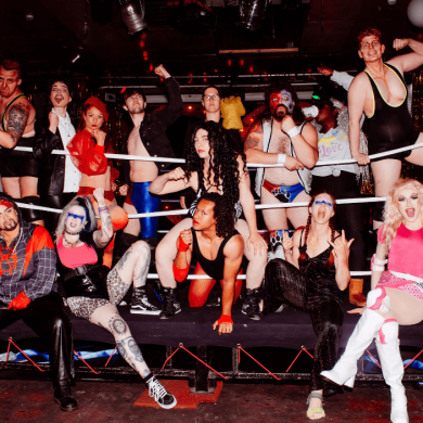 A group of people stood in a wrestling ring.