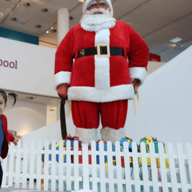A large statue of Santa in the atrium of Museum of Liverpool