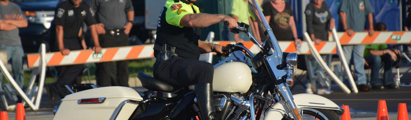 Amarillo motorcycle cop riding motorcycle through orange cones
