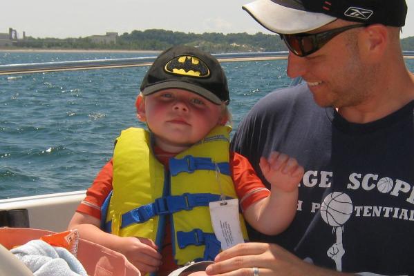Dad and child in fishing boat on Lake Michigan