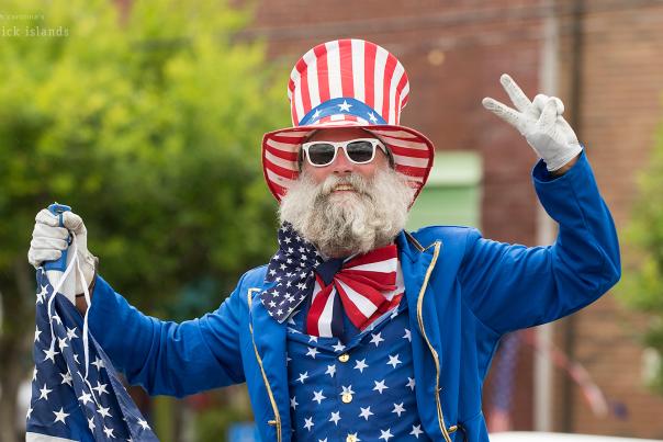 a man dressed up in a red, white, and blue USA outfit for the NC 4th of July Festival parade in Southport, NC