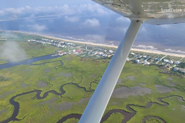 Caswell Beach and the oak island lighthouse as seen from the window of a small plane