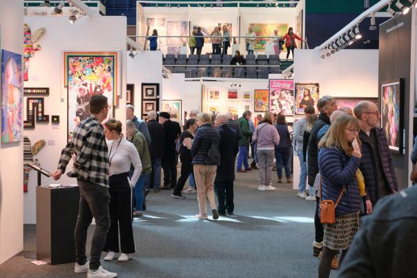 People looking at artwork at Fresh Art Fair Cheltenham