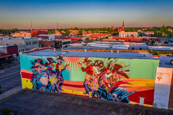 A beautiful mural adorns the brick of a public building on Garrison Avenue.