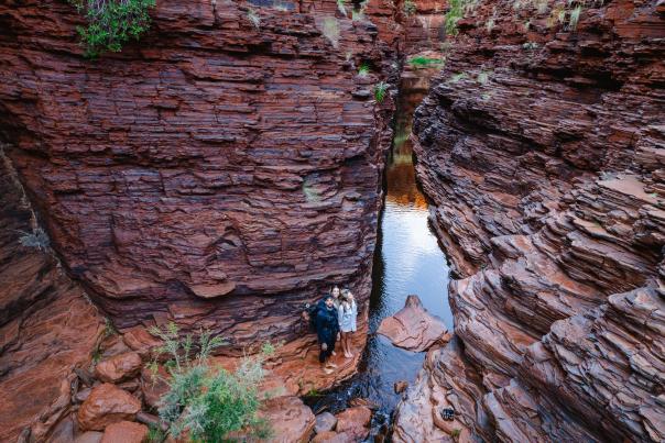 hikers looking at the walls of a gorge in Karijini National Park