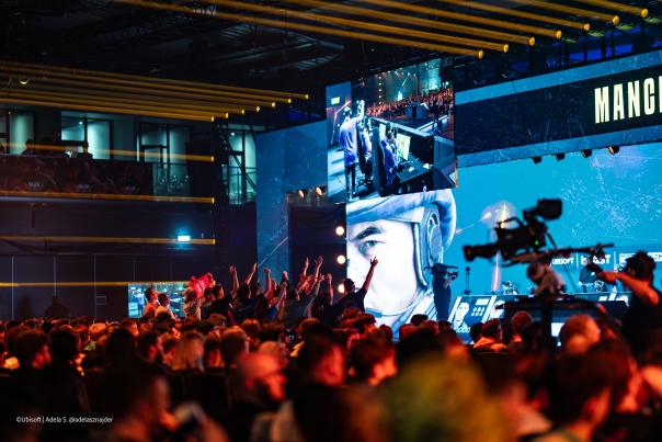 Crowd of people cheering in front of an e-sports stage