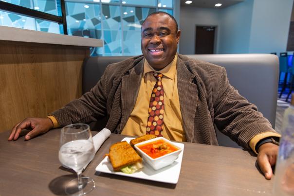 mayor judd smiling in front of plate of food