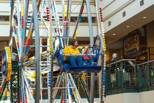 mom and daughter on Ferris Wheel in store