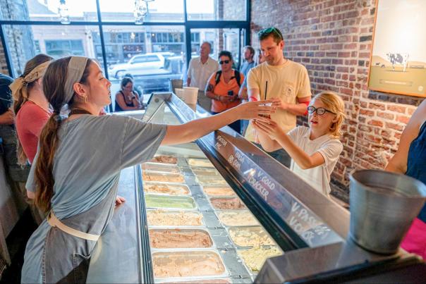 Employees serving ice cream to customers at Coneflower Creamery.