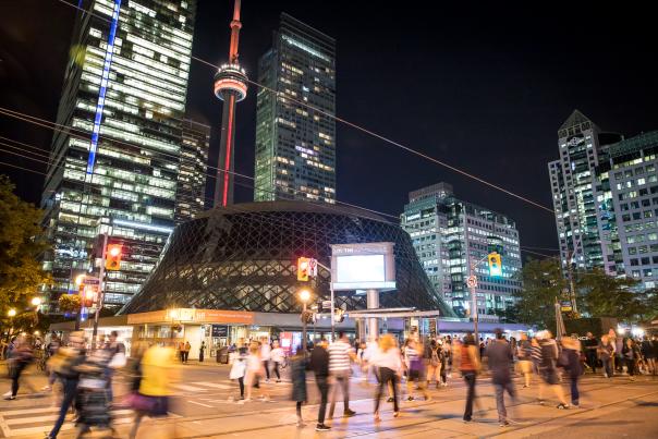 Crowds walking along King Street with Roy Thomson Hall in background
