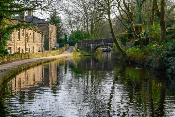Canal with stone bridge and cottages in Oldham