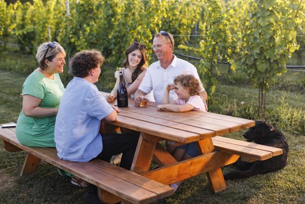 Sperling Vineyards Family enjoying wine on picnic table in the vineyard 2