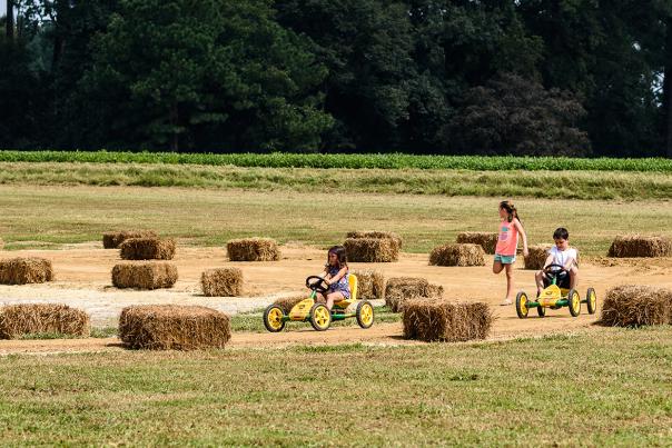Young kids riding pedal carts at Sonlight Farms in Kenly, NC.