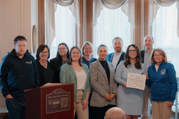 FLVC team receiving citation from New York State Senate recognizing the Finger Lakes Visitors Connection (FLVC)’s efforts in preserving and promoting local history.