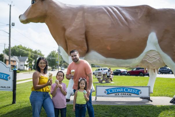 family in front of the Big Cow at Cedar Crest Ice Cream Parlor