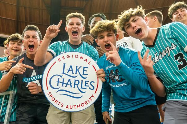 Group of boys in jerseys hold Lake Charles Regional Sports Authority sign