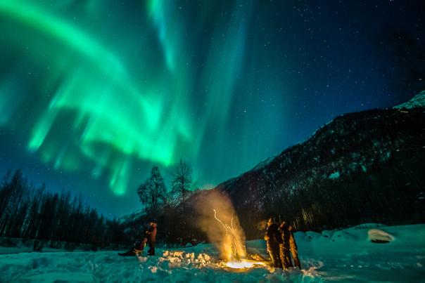 Travelers camp out to catch the northern lights near Anchorage.