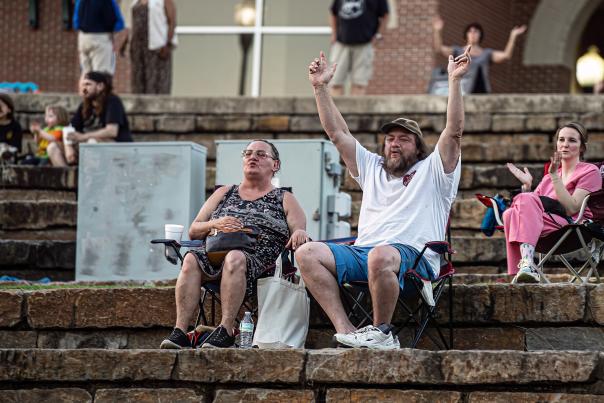 A man and woman cheer as they sit in lawn chairs at the Levitt Amp in Fort Smith, Arkansas