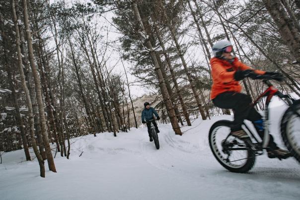 Two people fat tire biking on a fresh snowfall in the Upper Peninsula of Michigan
