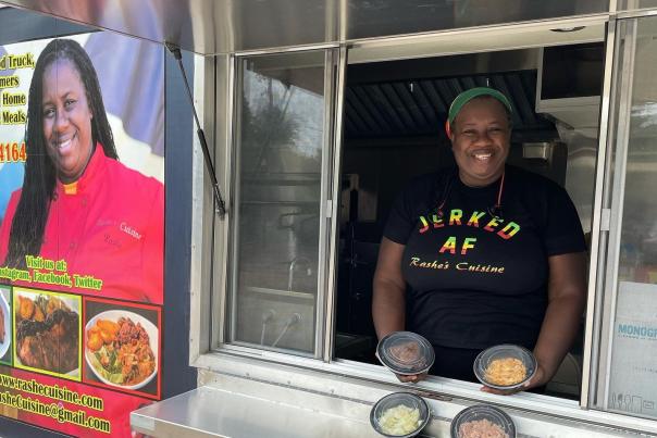 Owner of Rashe's Cuisine Rashe Malcolm serves food in the Rashe's Cuisine food truck.