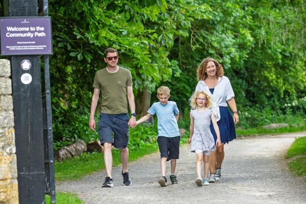 A family walking along the Community Path between Blenheim Palace and Hanborough train station