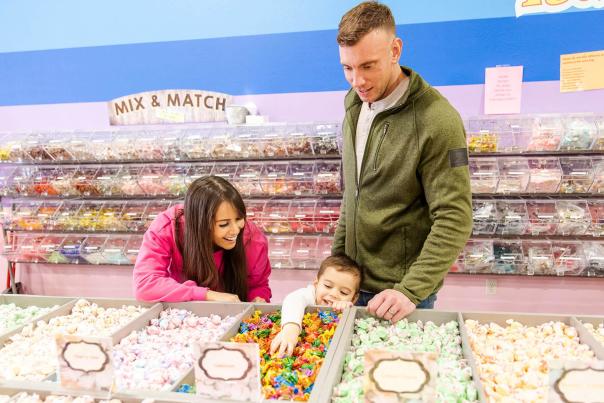 family shopping candy selection at rushmore candy company in rapid city