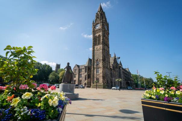 Rochdale Town Hall with planters and flowers in foreground