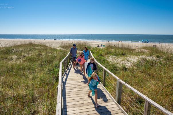 a family of five walking back to their car from the beach