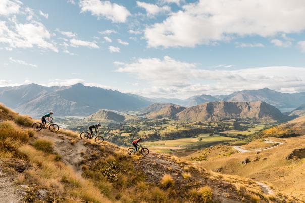Three mountain bikers on Pack Track and Sack Trail, Coronet Peak