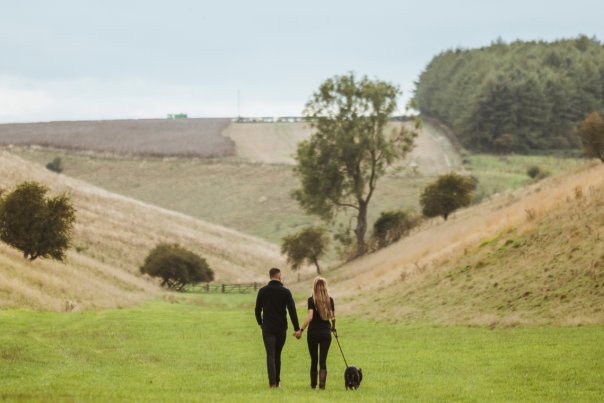 A couple with their dog walking on the Yorkshire Wolds