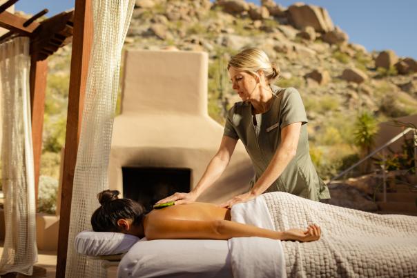 A woman receives a cactus massage at the Four Seasons Resort Troon North