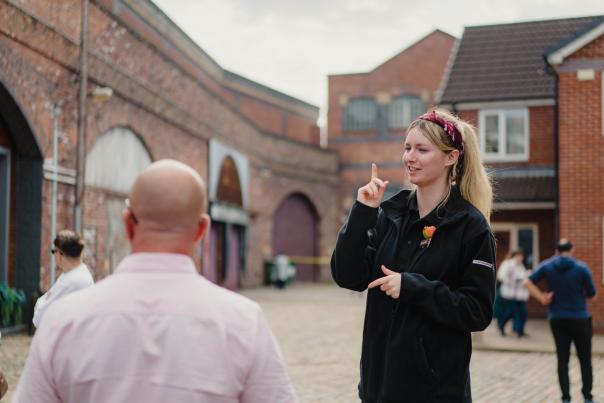 Guide on Coronation Street Tour set with visitors