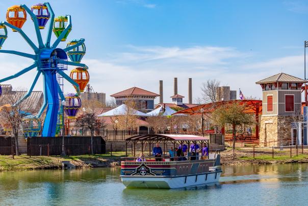 Ferris Wheel and boat overlooking water