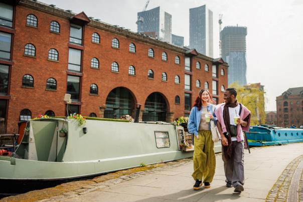 Image of a couple walking along the canal.