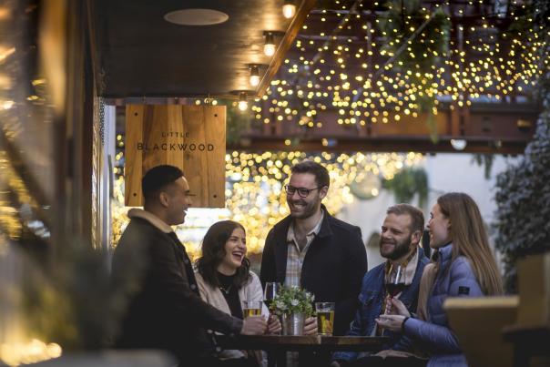 Group of people mingling at bar