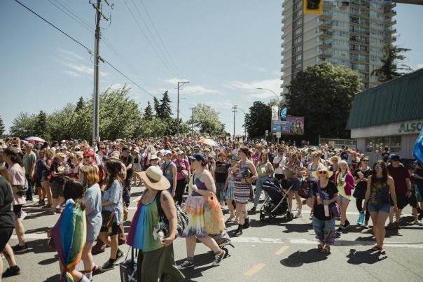 A large crowd of people celebrating pride.