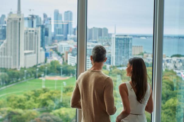 A couple looks out at the Toronto skyline from Hotel X
