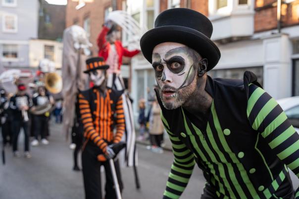 a halloween parade with people dressed as skeletons