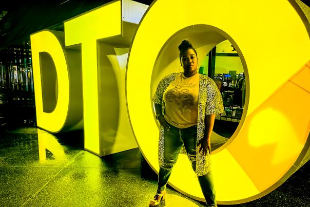 Orlando Looks - Experience. Influencer Katrina Dandridge in front of DTO sign