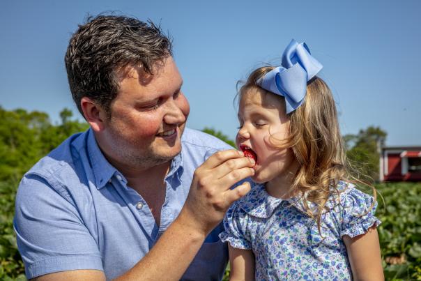 Little girl eating strawberry