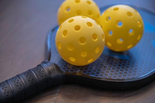 Three Pickleballs on a Paddle